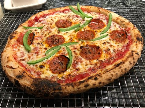 Peppers pizza - Sep 23, 2019 · Preheat oven to 450°. Roll pizza dough out on a floured surface until its desired thickness. Place dough onto pizza pan. Top with Arrabbiata sauce and roasted peppers and place in oven for 5 minutes. Remove pizza and place spoonfuls of ricotta on pizza. Then return to oven and bake until crust is golden brown (about 7-10 minutes). 